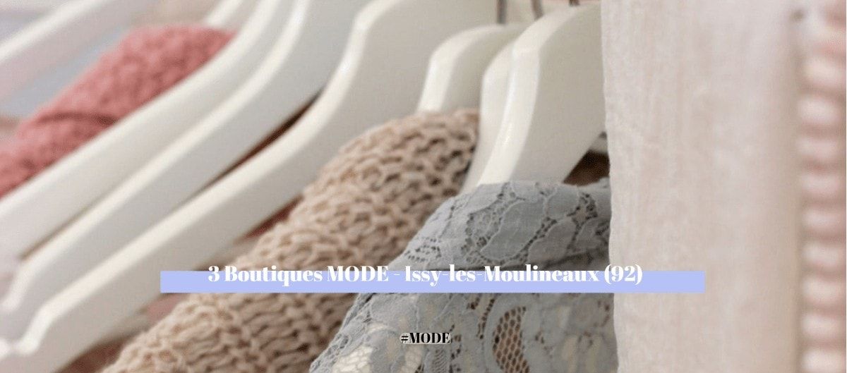 Vêtements en maille et dentelle suspendus à des cintres blancs dans une boutique de mode