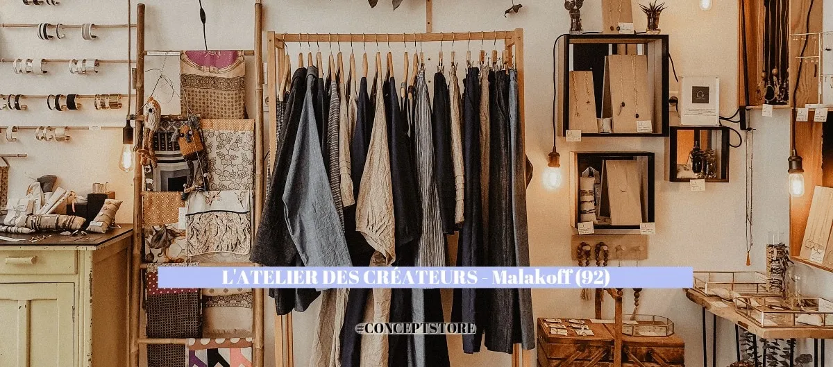 Intérieur du concept store L'Atelier des Créateurs à Malakoff, vêtements sur portant en bois et objets déco