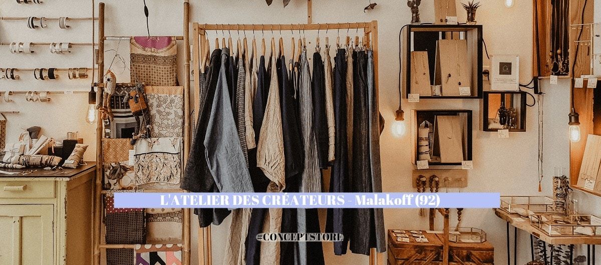 Intérieur du concept store L'Atelier des Créateurs à Malakoff, vêtements sur portant en bois et objets déco