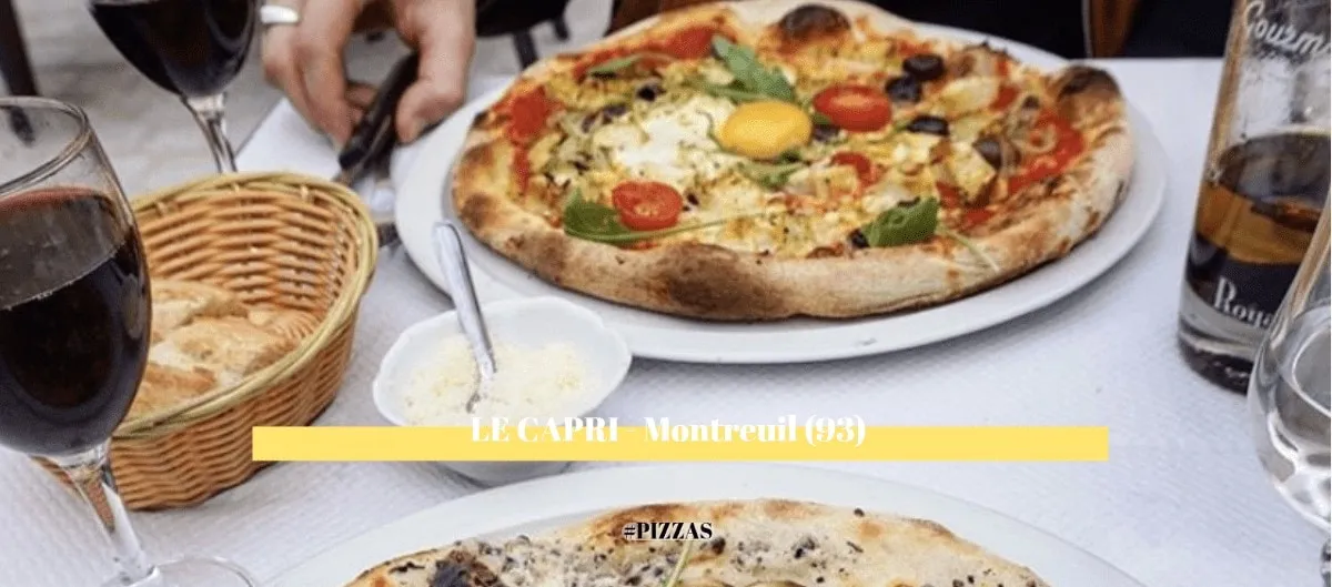 Pizzas et verres de vin au restaurant Le Capri à Montreuil